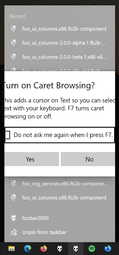 A dialogue box asking to turn on caret browsing, but over a taskbar item context menu, and with the sides cut off.